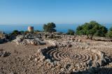 A (modern) spiral built inside an ancient threshing floor on the peninsula above Loutro. The tower in the background is an old windmill
